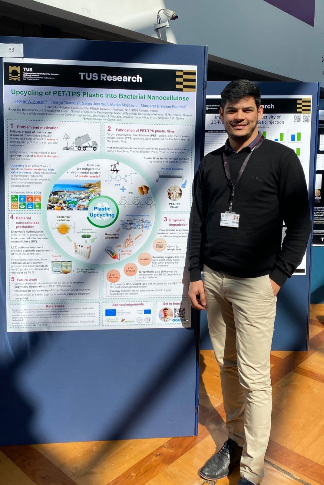 Jeovan Araujo standing next to his poster presentation